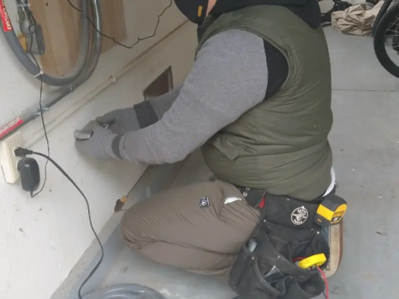 Electrician performing outlet wiring in a Los Alamitos garage